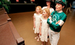 Thoroughbred jockey Emma-Jayne Wilson, right, stands with her family as she watches the re...