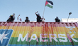 Pro-Palestinian protesters block a Maersk container during the Warsaw Equality Parade in W...