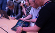 A general view shows people checking the new Huawei laptop in front of the Huawei stand at...