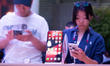 A general view shows people checking the new Huawei cell phone in front of the Huawei stan...