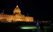 A television crew broadcasts at a candlelight vigil outside the state Capitol building in...