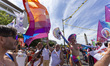 People wave flags during the EuroPride LGBTQ+ parade in Lisbon, Portugal, on June 21, 2025...