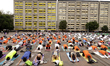 People participate in a yoga mass class to celebrate the annual International Yoga Day at...