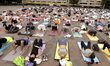 People participate in a yoga mass class to celebrate the annual International Yoga Day at...