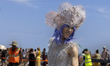 A costumed marcher poses for photos at the 2025 Coney Island Mermaid Parade in Brooklyn, N...