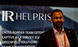 HR Helprise logo is seen as participants browse among exhibitors stands during the first d...