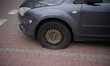 A car with a flat tire is seen in Warsaw, Poland on 24 June, 2025. 