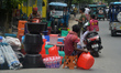 Roadside temporary sellers sell plastic items used for household needs like buckets and po...