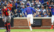 New York Mets' Juan Soto (22) scores on a sacrifice fly during the fourth inning of a base...