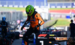 Lando Norris of the McLaren F1 Team drives and celebrates after qualifying during the 12th...