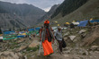 A handicapped Sadhu, or Hindu holy man, arrives at Baltal Base Camp, where he spends the n...