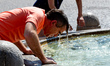 European summers get brutally hot. A man cools off during an ongoing heat wave with temper...