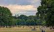 People gather on the meadow, play volleyball, and relax with a view of the Frauenkirche to...