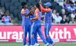 Radha Yadav of India, number 21, celebrates taking the wicket of Paige Scholfield of Engla...