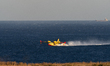 A Canadair aircraft refills with water from Adriatic coast, in Otranto, in the southern re...