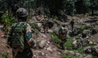 Indian soldiers of the Border Security Forces (BSF) patrol near the entry point towards Ba...
