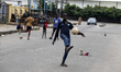 Children play football on the street in Ogba as Lagos State conducts elections for its 20...
