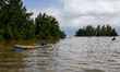A man rides on a boat through the area of sea waters contaminated by a nickel mine in Nort...