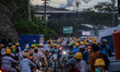 Employees are in traffic during the working shift change near Indonesia Morowali Industria...