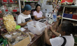 Claudia Morales (pink), an artisan, is in her shop during a sale of crystallized candy in...