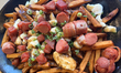 Poutine with bacon and sausage is served at a restaurant in Old Quebec City, Quebec, Canad...