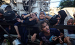 Palestinians gather at a food distribution point in Gaza City, on July 20, 2025. The World...