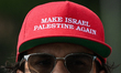 EDMONTON, CANADA – JULY 20:A protester wears a cap reading 'Make Israel Palestine Again'...