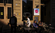 People sit at the outside tables of a bar in the area of Mitte in Berlin, Germany, on July...