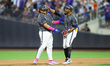 New York Mets Francisco Alvarez (4) receives a tap on the helmet from 1B coach Antoan Rich...