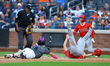 Los Angeles Angels player Nolan Schanuel (18) is tagged out by New York Mets catcher Franc...