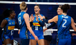 Anna Danesi and her teammates celebrate after scoring a point during the volleyball match...