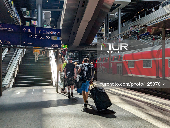 Berlin Main Station With Regional Train And Travelers