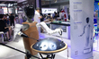 A humanoid robot plays music at the Shanghai New Expo Center during the opening day of the...