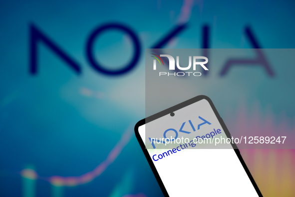The Nokia logo is displayed on a mobile phone with Nokia in the background in this photo illustration in Brussels, Belgium, on July 26, 2025...