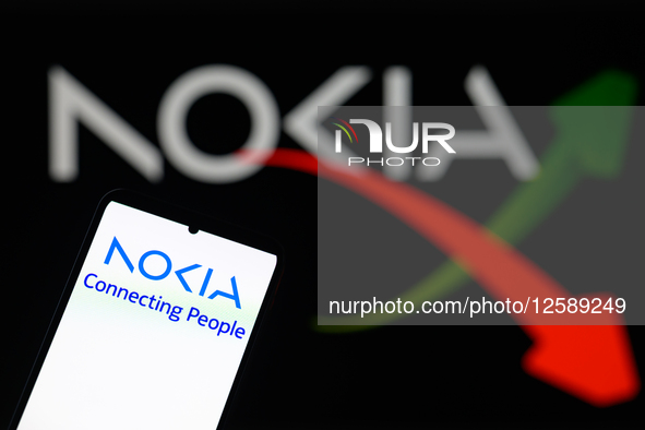 The Nokia logo is displayed on a mobile phone with Nokia in the background in this photo illustration in Brussels, Belgium, on July 26, 2025...