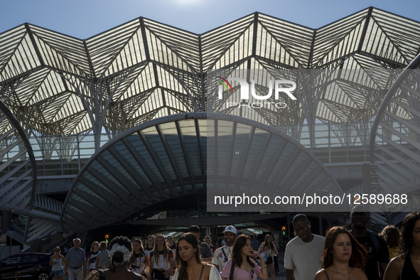 People walk away from Oriente Metro and Train Station in Lisbon, Portugal, on July 26, 2025. The area, built for Expo '98, features wide pro...