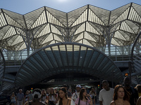 People walk away from Oriente Metro and Train Station in Lisbon, Portugal, on July 26, 2025. The area, built for Expo '98, features wide pro...