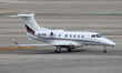 An Embraer Phenom 300 of NetJets heads for the Barcelona-El Prat Airport runway in Barcelo...
