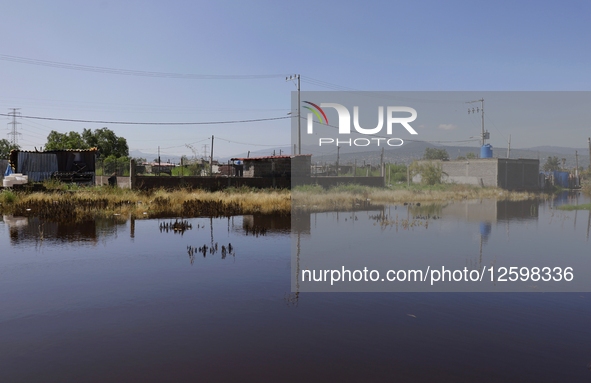 Homes are affected by the partial overflow of the La Cienega canal in Tlahuac, Mexico City, on July 29, 2025, which is exacerbated by low-ly...
