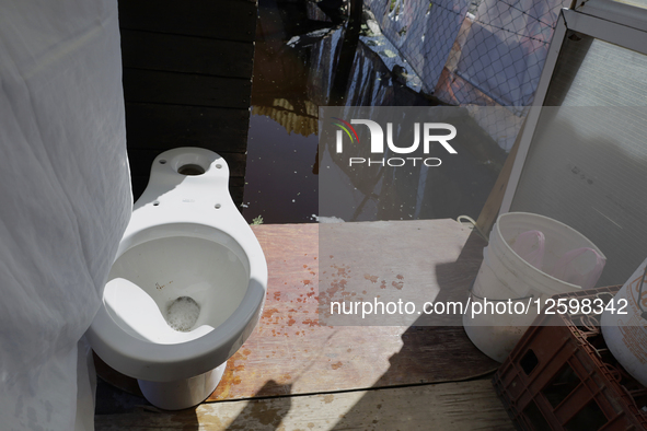 Homes are affected by the partial overflow of the La Cienega canal in Tlahuac, Mexico City, on July 29, 2025, which is exacerbated by low-ly...