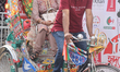 People pose for photos in a rickshaw during the Festival of South Asia in Toronto, Ontario...