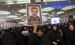 A veiled Iranian woman carries a portrait of former Deputy Chief of Staff of the Iranian A...