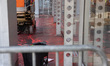 Red paint mixed with water runs across the sidewalk in front of The New York Times Buildin...