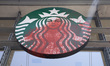 Red paint splashes across the sign of the Starbucks coffee shop adjacent to The New York T...