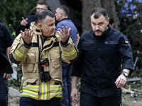 In Kyiv, Ukraine, on August 1, 2025, Interior Minister Ihor Klymenko and State Emergency Service Chief Andrii Danyk inspect a multi-storey r...