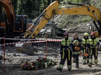 Rescuers walk in front of a multi-storey residential building that is hit by a Russian missile strike in Kyiv, Ukraine, on August 1, 2025, a...