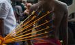 A devotee has ropes tied around his body with thorns during the annual Theru festival in C...