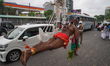 A devotee suspends himself with hooks during the annual Theru festival in Colombo, Sri Lan...