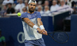 Karen Khachanov of Russia plays a backhand against Ben Shelton of the United States during...