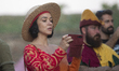 A woman in costume holds a phone at a Serbian medieval festival at Petrovaradin Fortress i...
